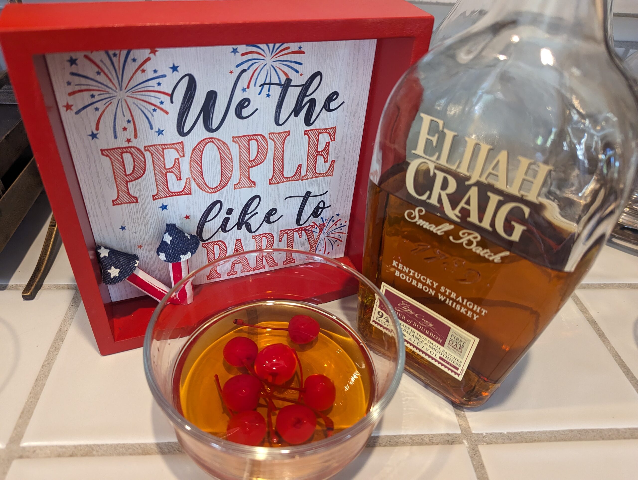 4th of july themed elijah craig whiskey and cherries soaking in whiskey