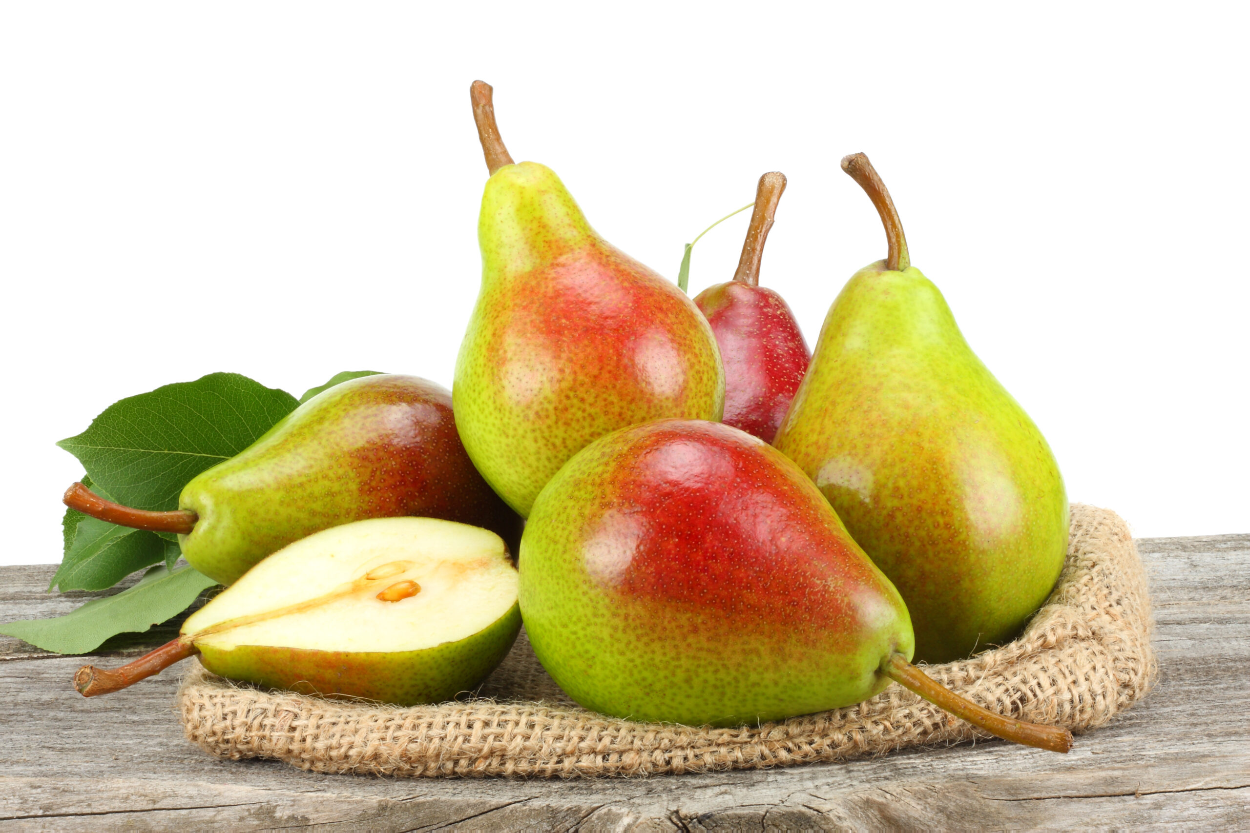 comice pear with leaf on old wooden table with white background